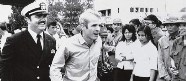 Lieutenant Commander Jay Coupe escorting Lieutenant Commander John McCain in Hanoi